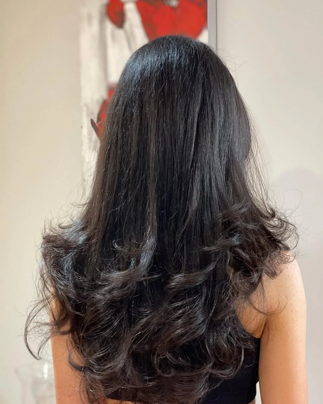 chic summer haircuts for long hair 2026 Voluminous Flipped Layers With Glossy Black Shine