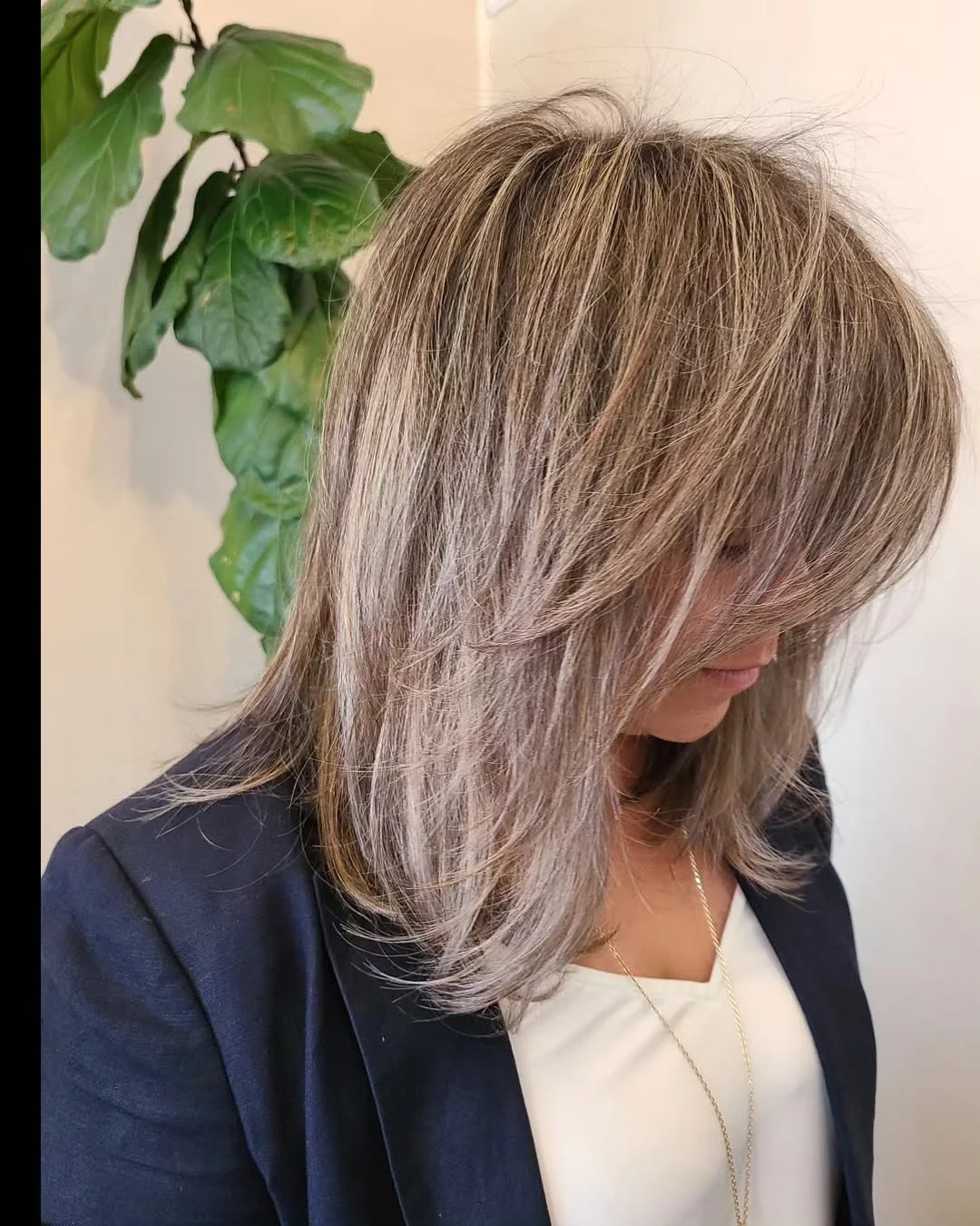 feathered summer haircuts for medium hair 2026 Voluminous Silver Feather Layers With Side-Swept Drama