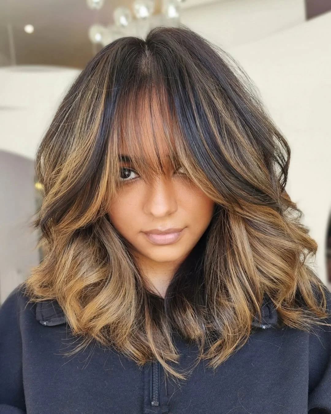 feathered summer haircuts for medium hair 2026 Golden Bronde Feather Layers With Airy Curtain Bangs