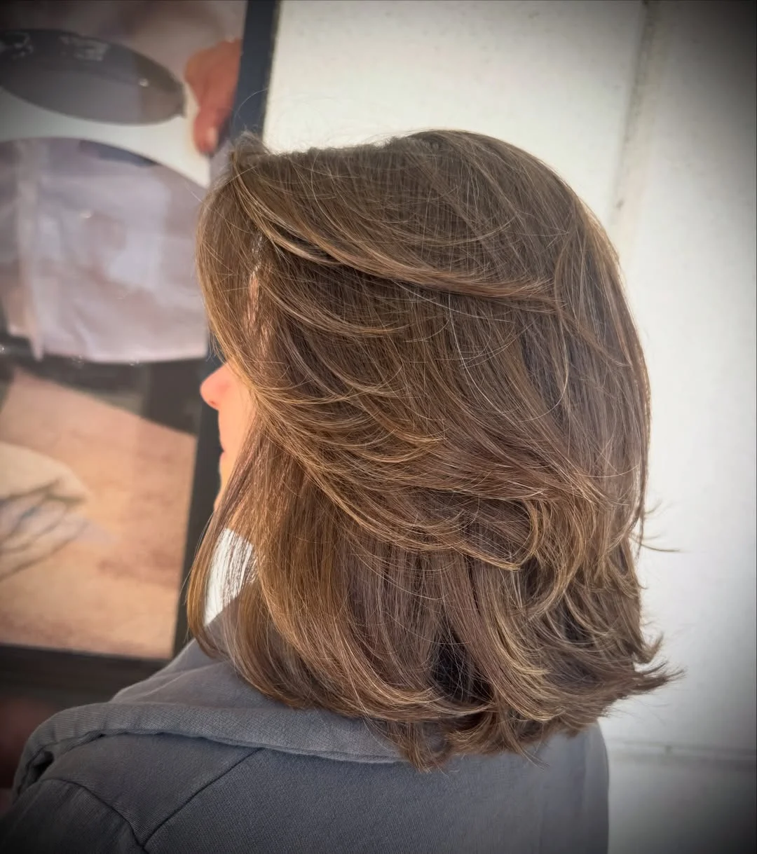 feathered summer haircuts for medium hair 2026 Glossy Feathered Layers With a Blowout Finish