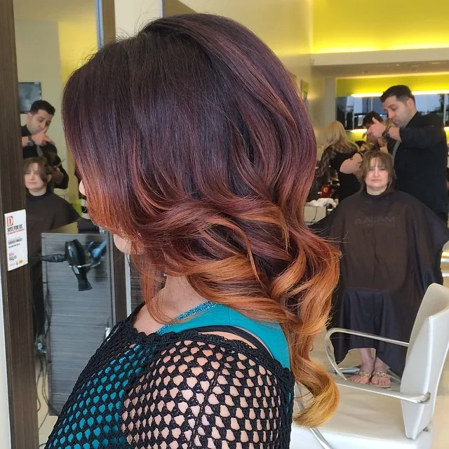 flattering summer ombre hair color 2026 Deep Burgundy to Golden Amber Low Pony Blend