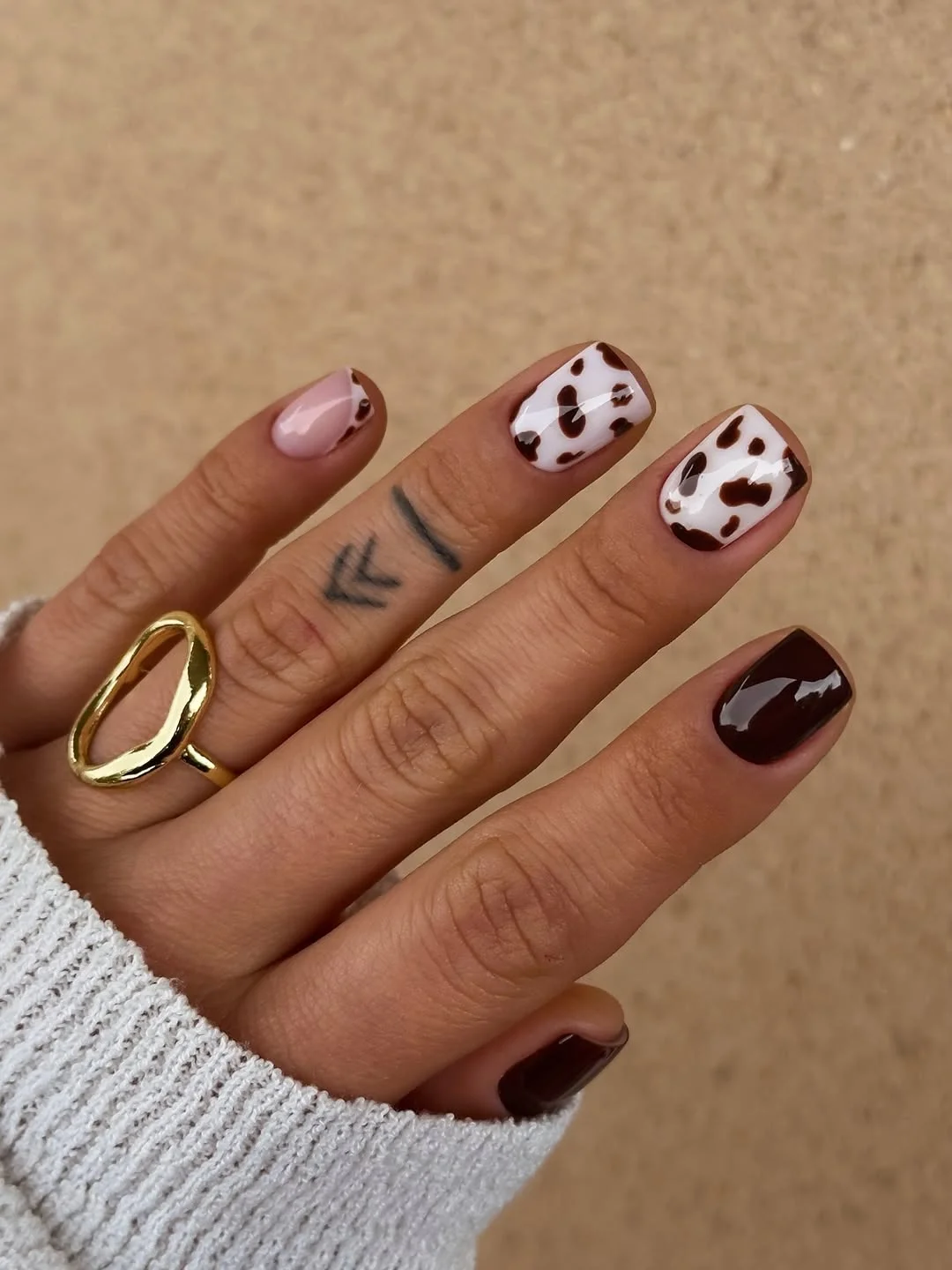 june nail colors 2026 Chocolate Cow Print Nails with Trendy Neutral Contrast