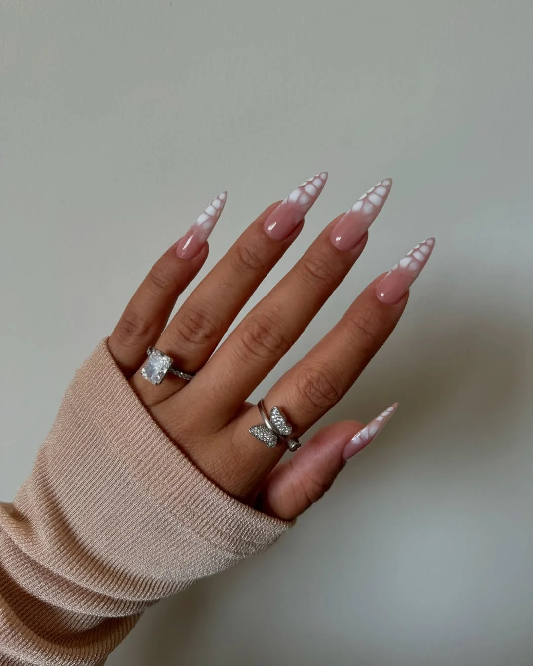 june nails ideas 2026 Soft White Aura Stiletto Nails for Minimal Glam