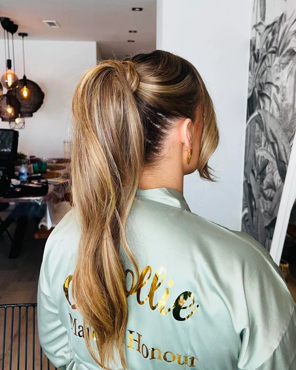 messy summer ponytail hairstyle 2026 Glossy Wrapped Ponytail With Soft Blonde Dimension