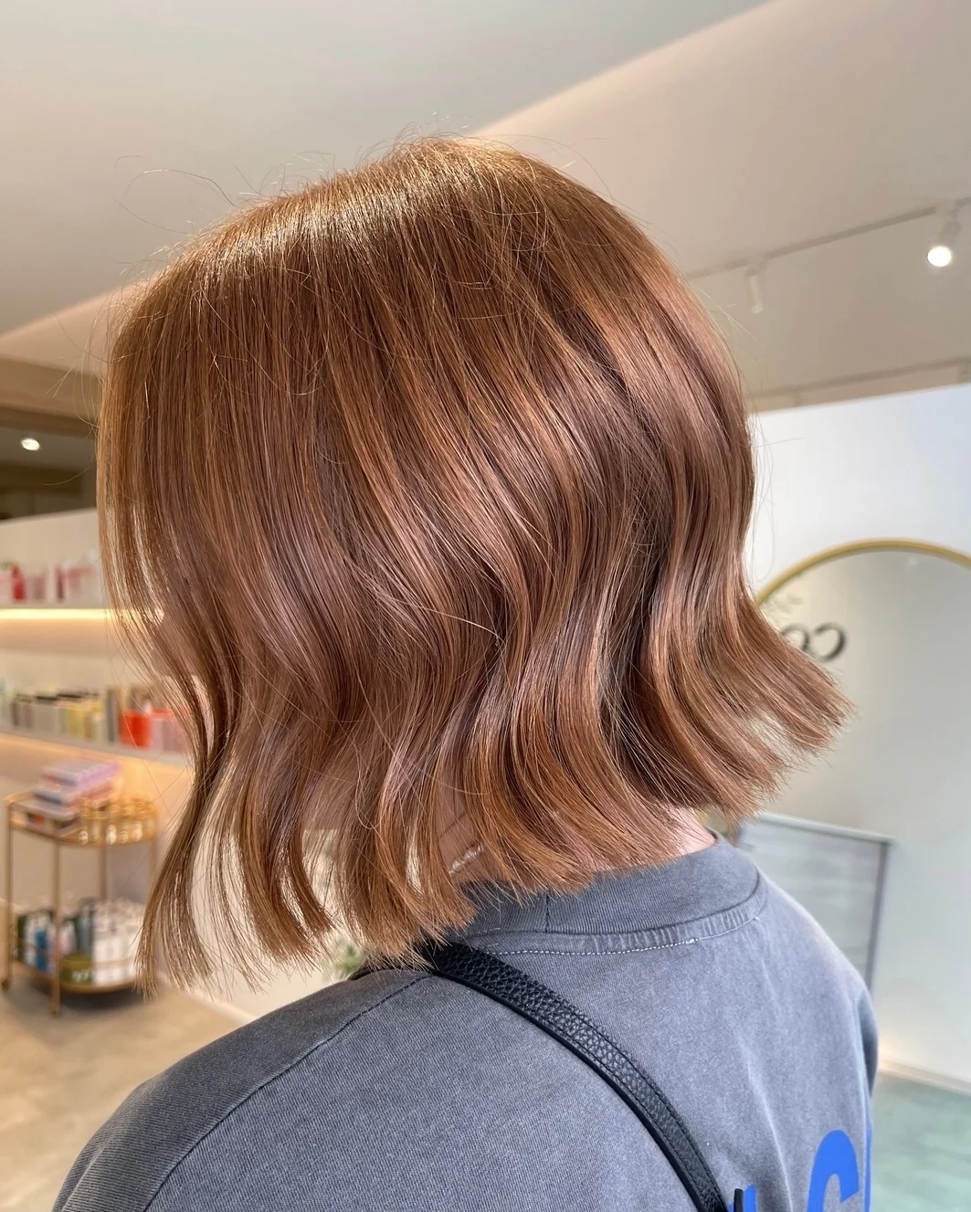 modern summer auburn hair color 2026 Muted Cinnamon Bob With Soft Parisian Texture