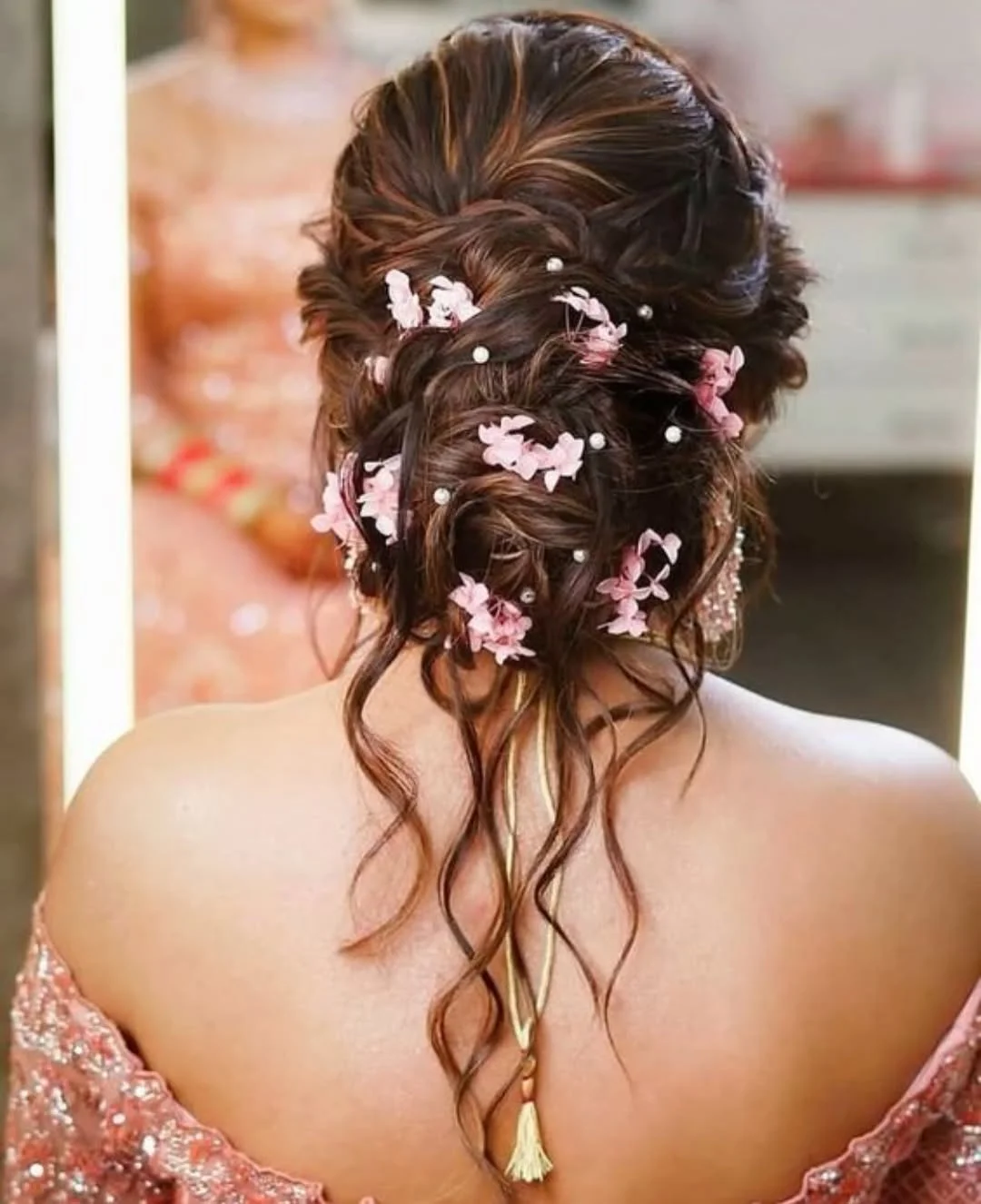 natural summer bun hairstyles 2026 Romantic Floral Bun With Soft Twists