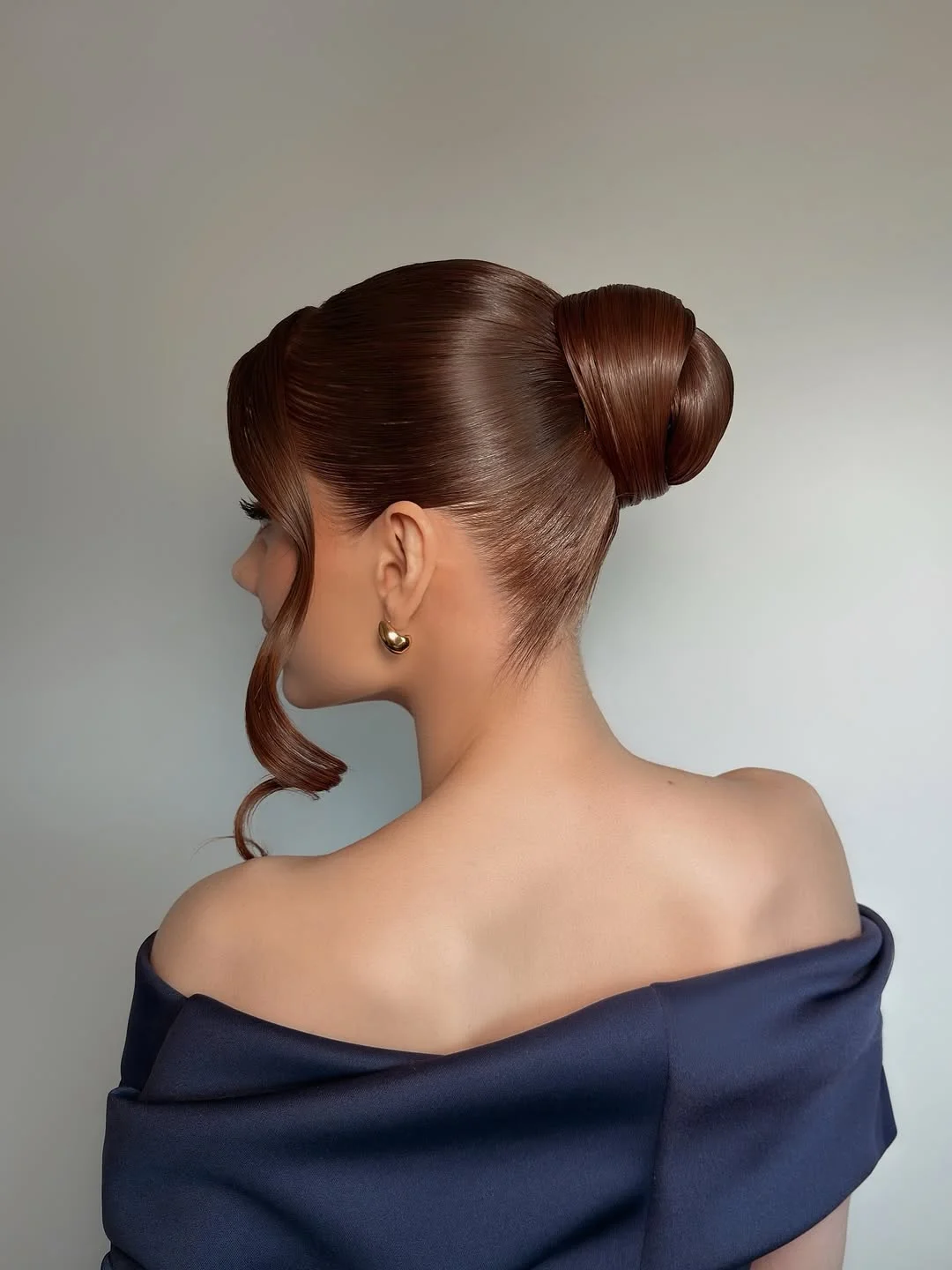 natural summer bun hairstyles 2026 Sculpted High Bun With Runway Gloss