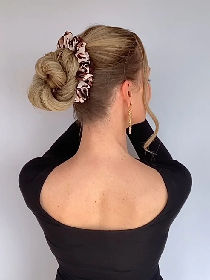 natural summer bun hairstyles 2026 Soft Scrunchie Bun With Casual Cool Girl Energy