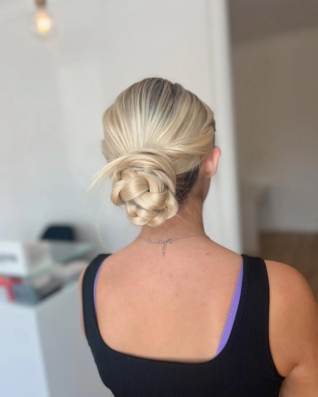 natural summer bun hairstyles 2026 Soft Braided Knot Bun With Minimalist Elegance