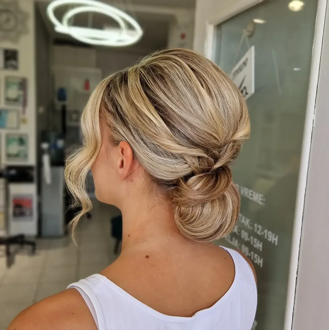 natural summer bun hairstyles 2026 Dimensional Blonde Bun With Soft Twisted Texture
