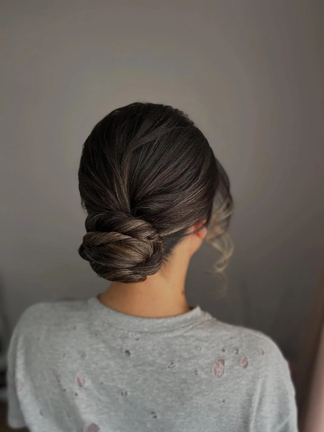 natural summer bun hairstyles 2026 Sleek Espresso Bun With Modern Simplicity