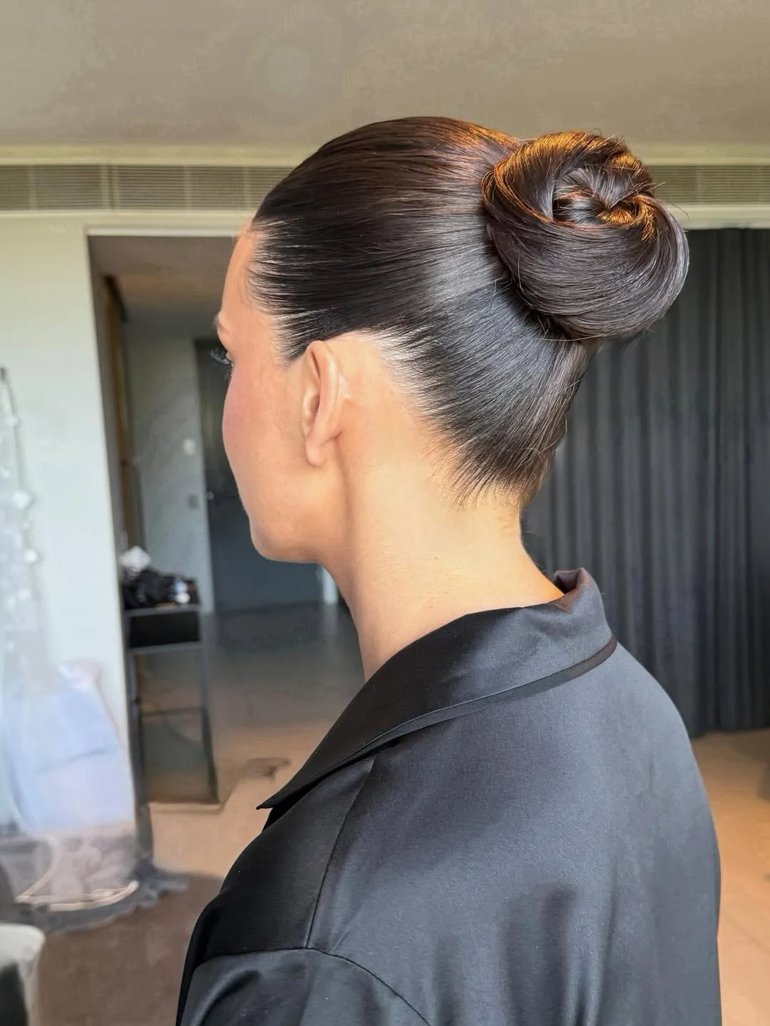 natural summer bun hairstyles 2026 Glass Hair Sleek Bun With Minimal Luxury Finish