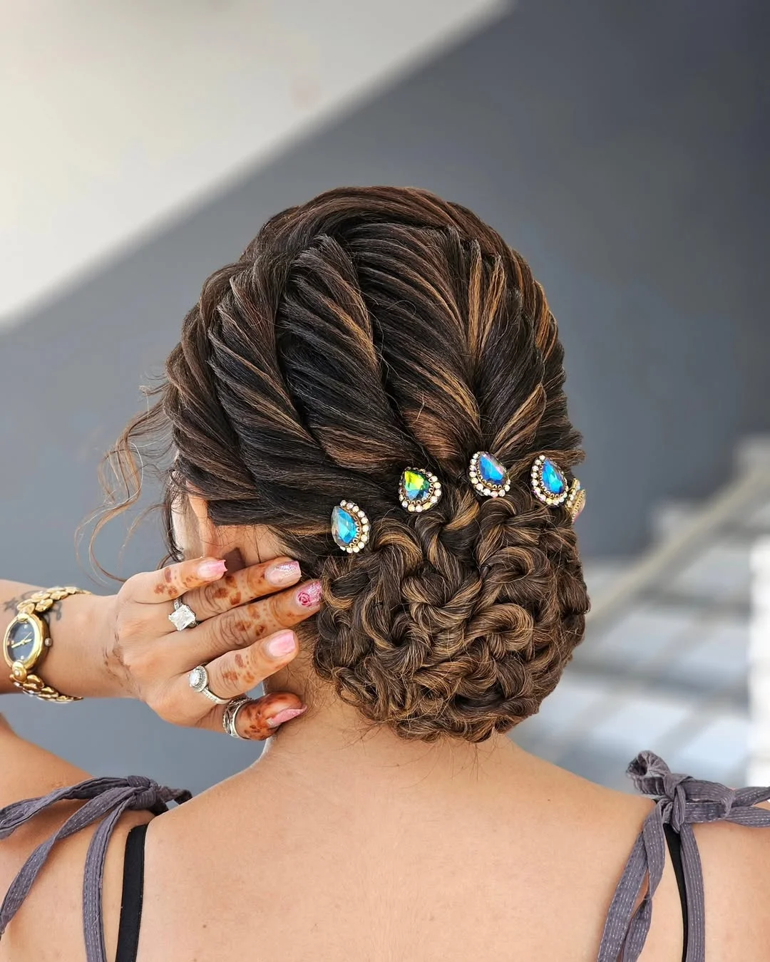 natural summer bun hairstyles 2026 Jewel Pinned Twisted Bun With Soft Glam Texture