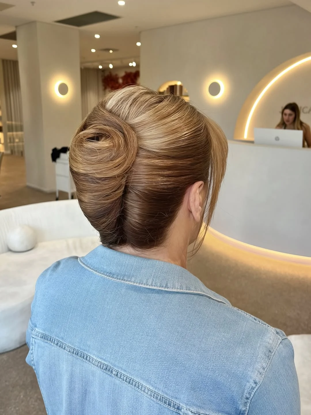 natural summer bun hairstyles 2026 Glossy French Twist Bun With Modern Volume