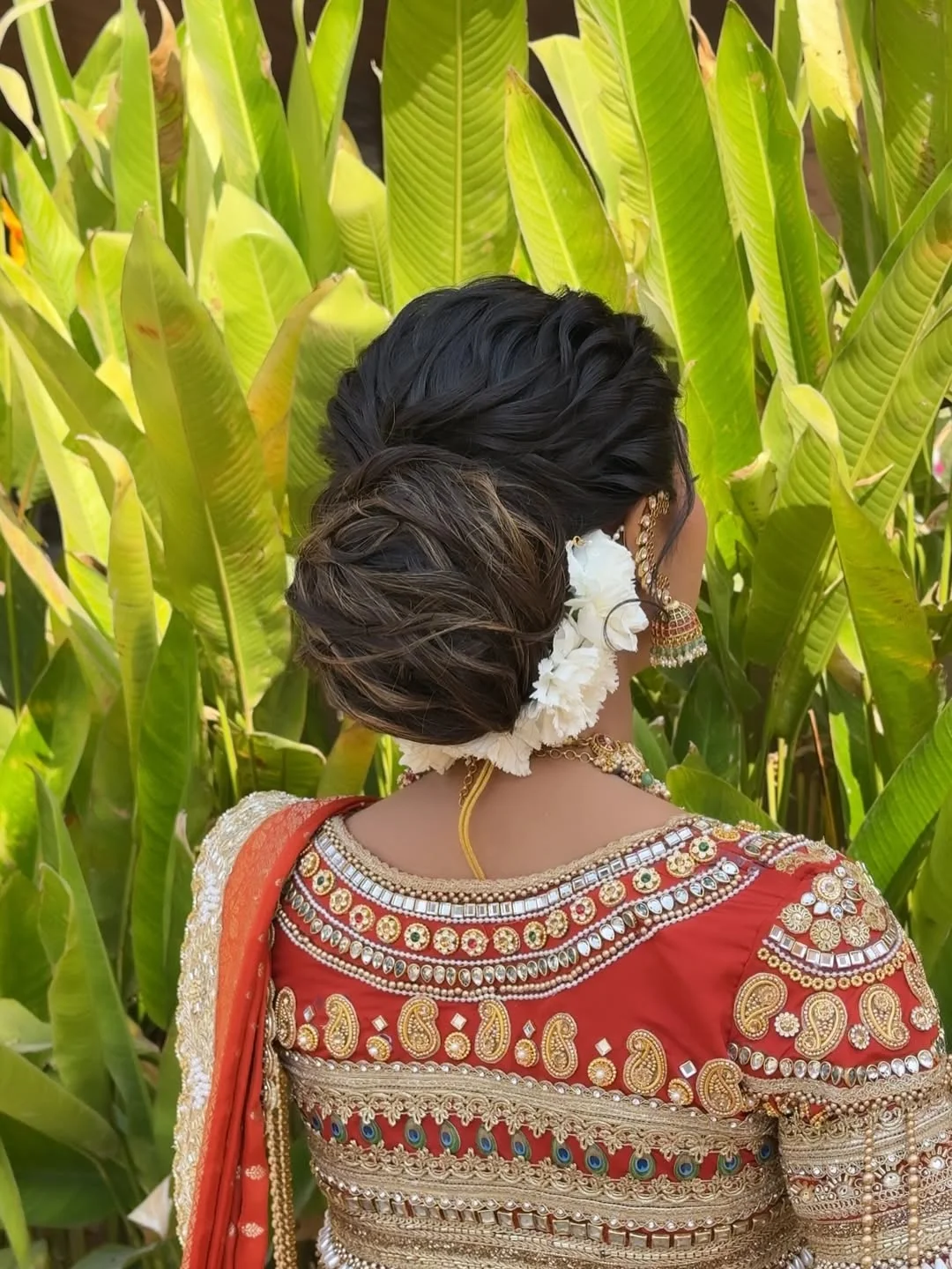 natural summer bun hairstyles 2026 Voluminous Floral Bun With Rich Summer Romance