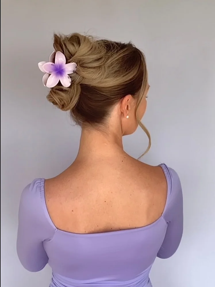 natural summer easy hairstyle 2026 Elegant Twisted Bun With a Tropical Clip Accent