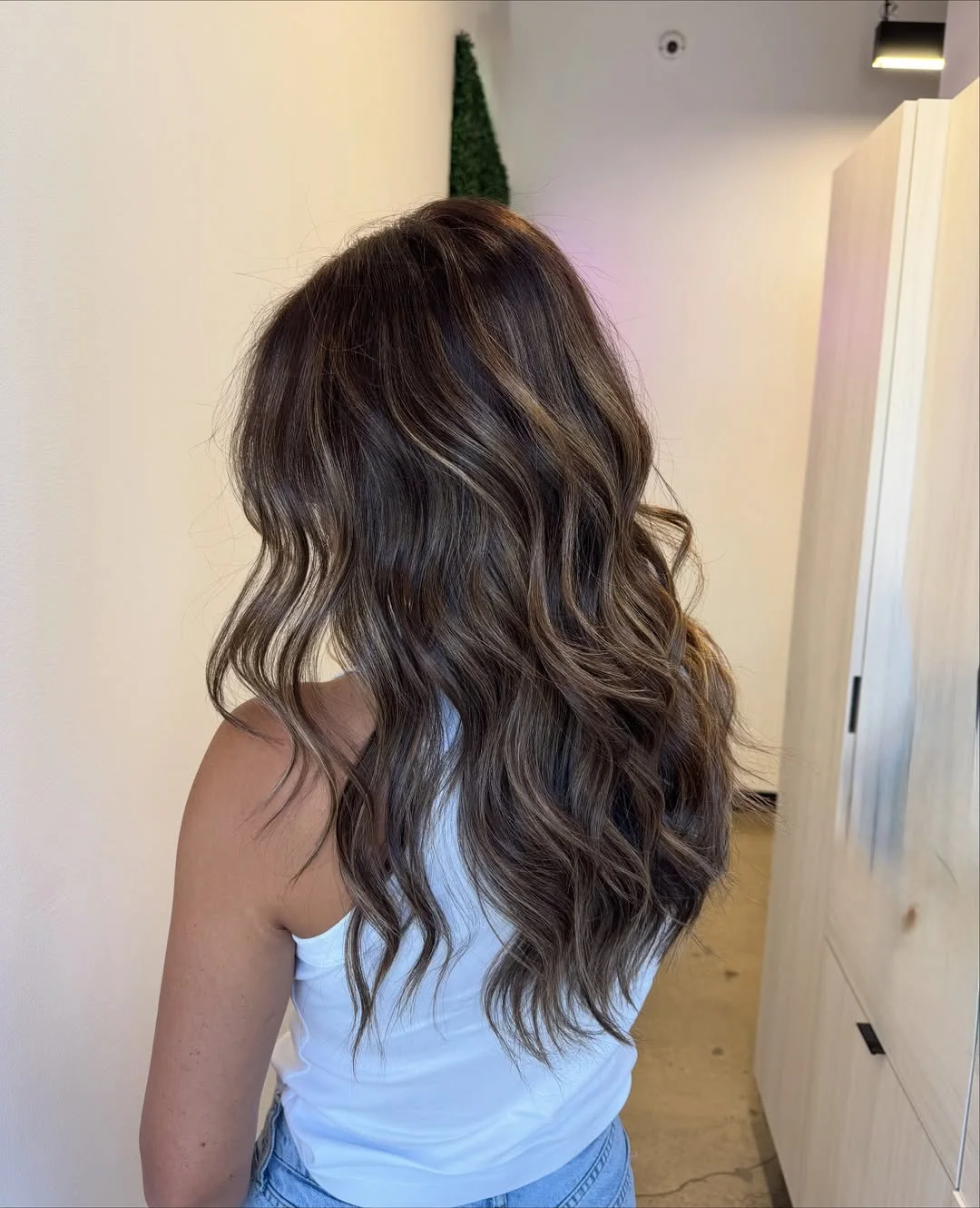 summer hair color ideas to inspire you 2026 Sunlit ash brown waves with soft dimension