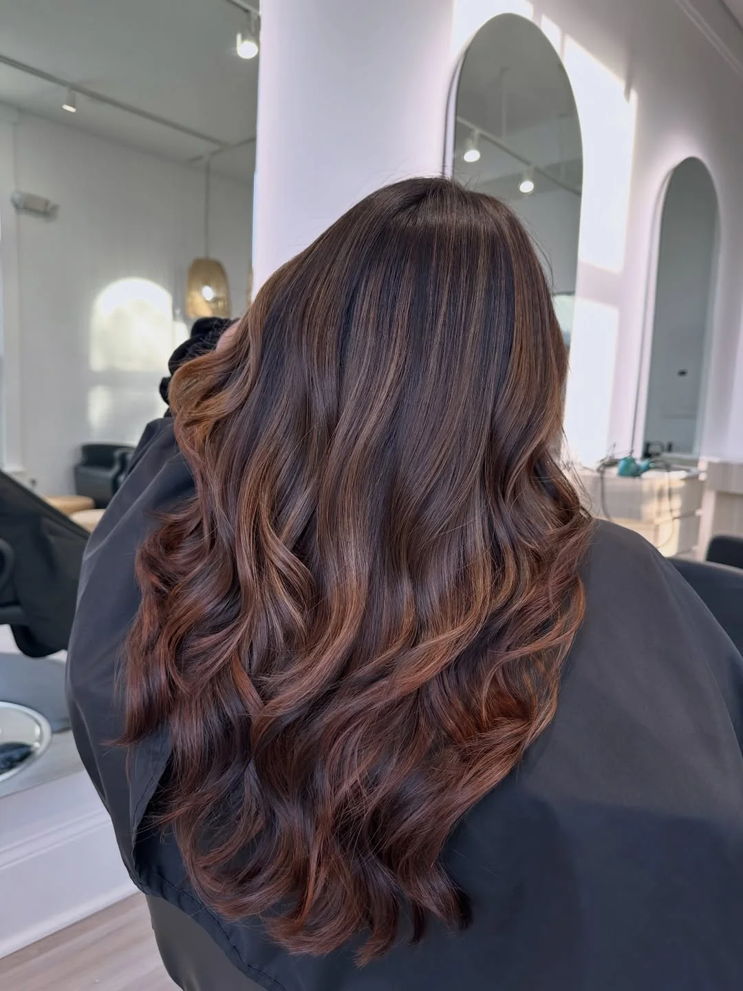 summer hair color ideas to inspire you 2026 Rich chocolate waves with subtle red undertones