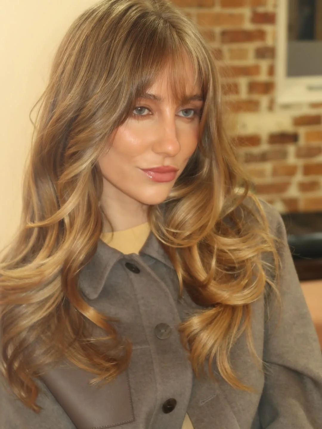 pretty summer honey blonde hair color 2026 Golden Caramel Honey Blonde With Feathered Curtain Bangs