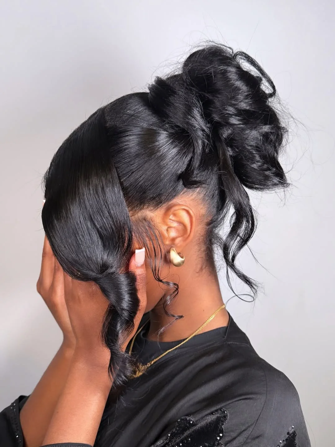 refined summer wedding guest hairstyles 2026 Sleek High Bun With Sculpted Glam Waves