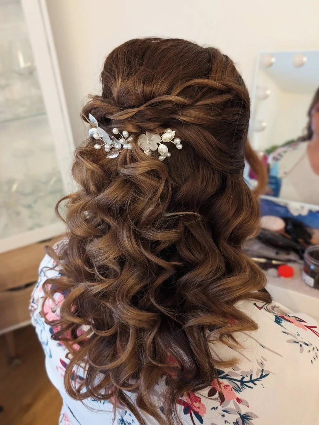 refined summer wedding guest hairstyles 2026 Voluminous Romantic Curls With Twisted Floral Detail