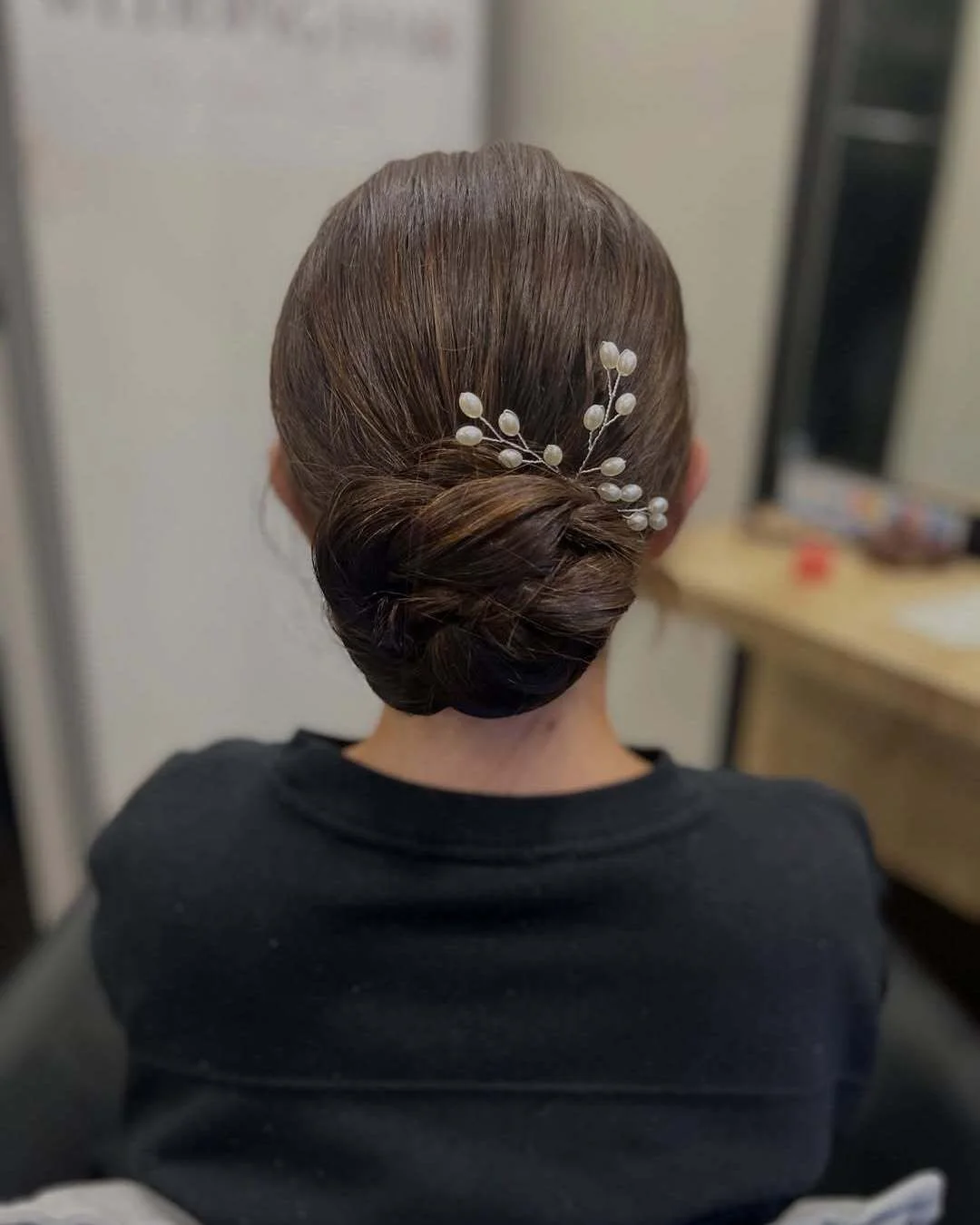 refined summer wedding guest hairstyles 2026 Polished Low Knot With Pearl Accent