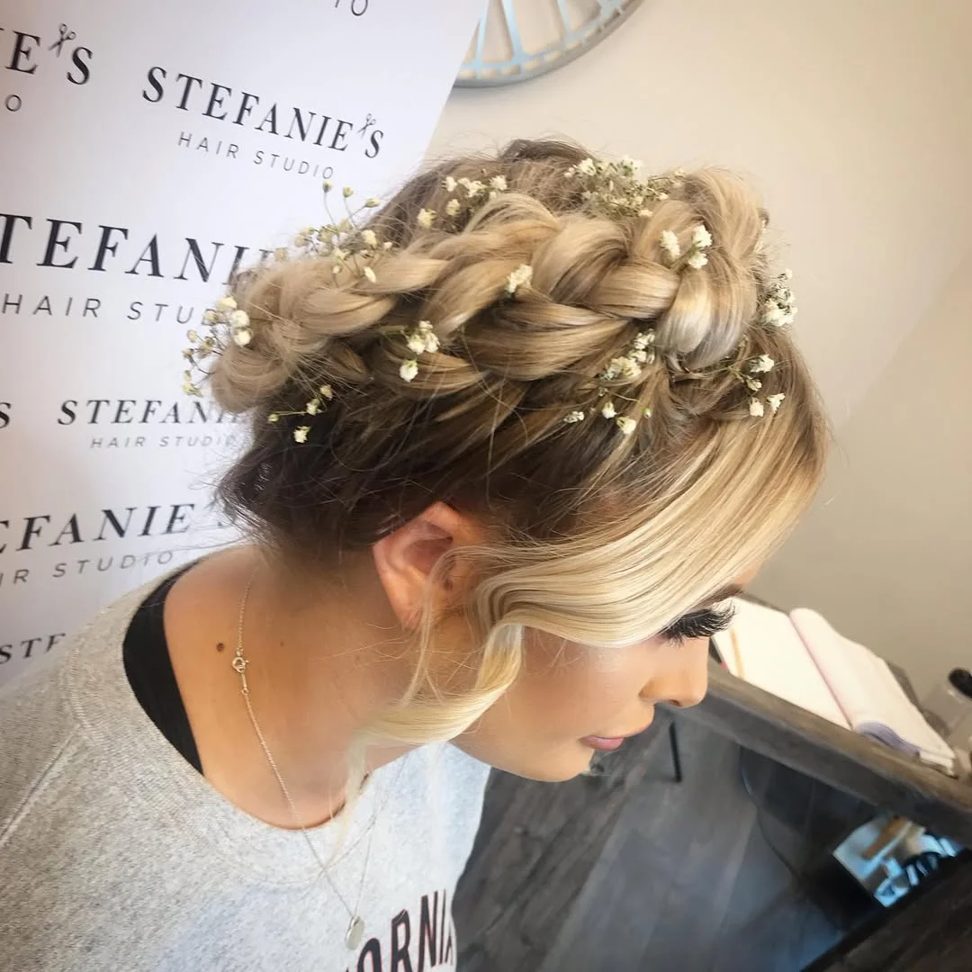 refined summer wedding guest hairstyles 2026 Bohemian Braided Updo With Baby’s Breath