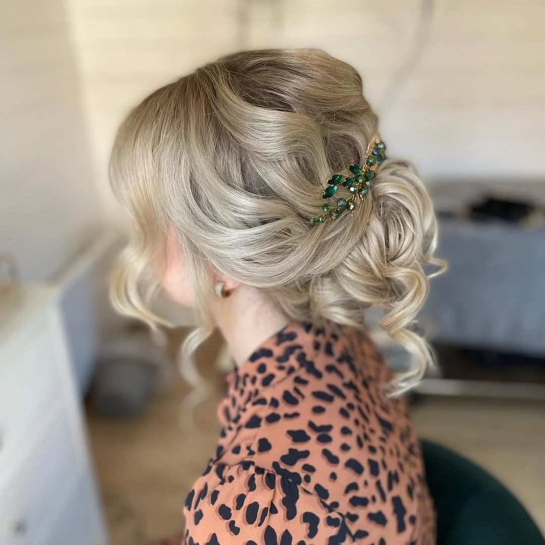 refined summer wedding guest hairstyles 2026 Elegant Twisted Blonde Chignon With Statement Clip