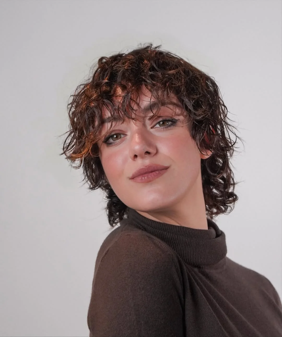 salon summer short haircuts 2026 Wet Texture Curly Shag With Copper Flickers
