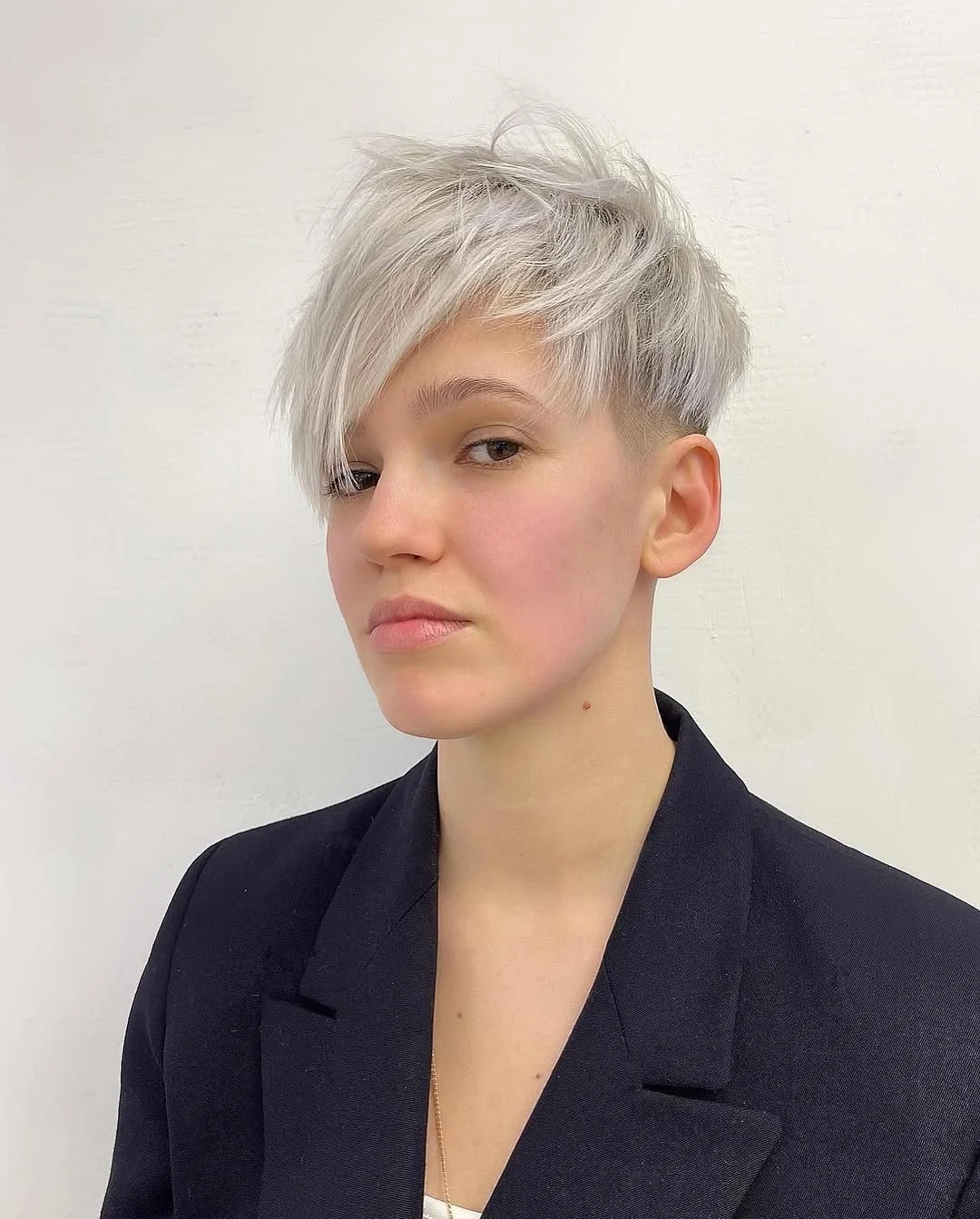 salon summer short haircuts 2026 Ice Blonde Undercut Pixie With Editorial Volume