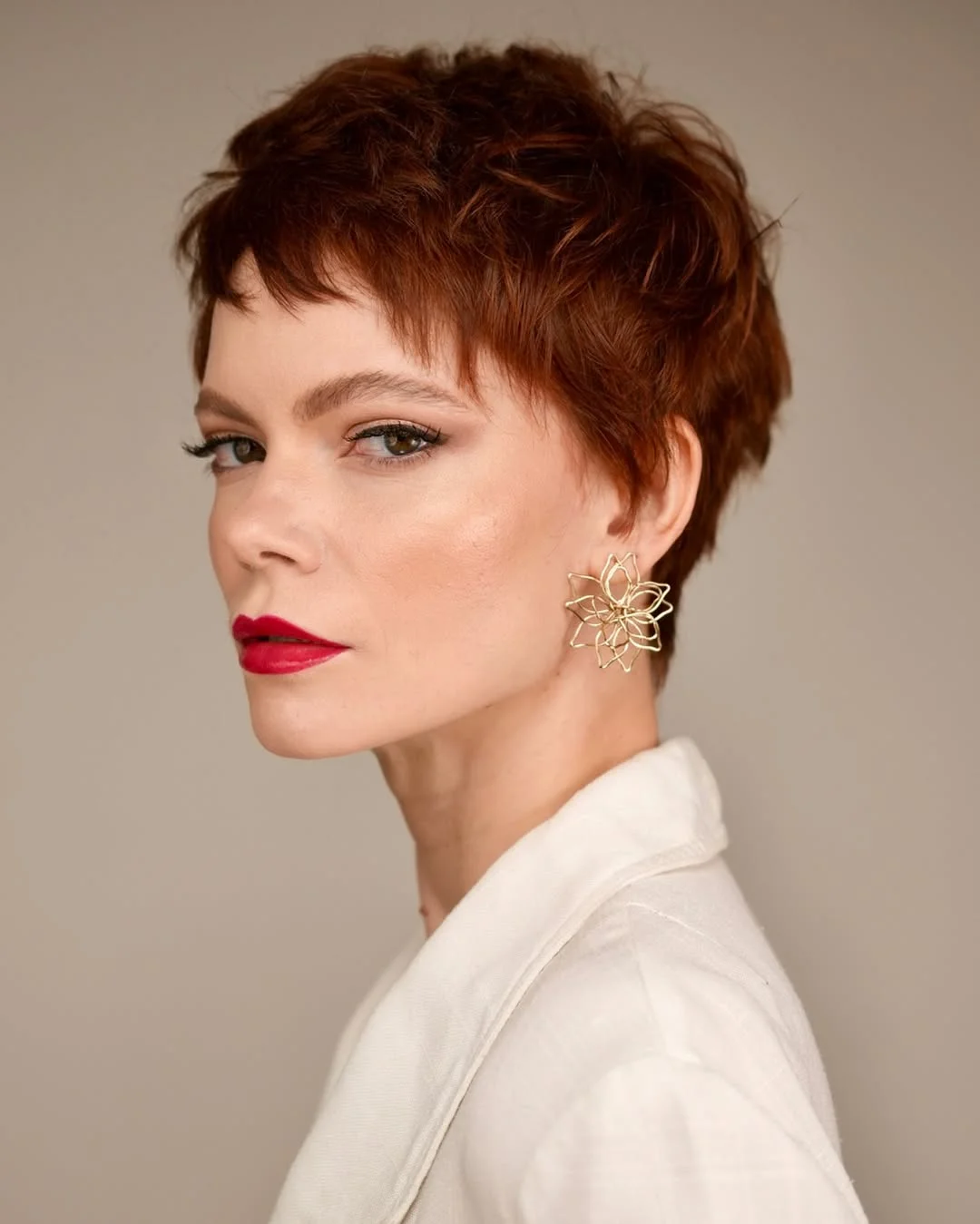 salon summer short hairstyles 2026 French Inspired Auburn Pixie With Piecey Layers