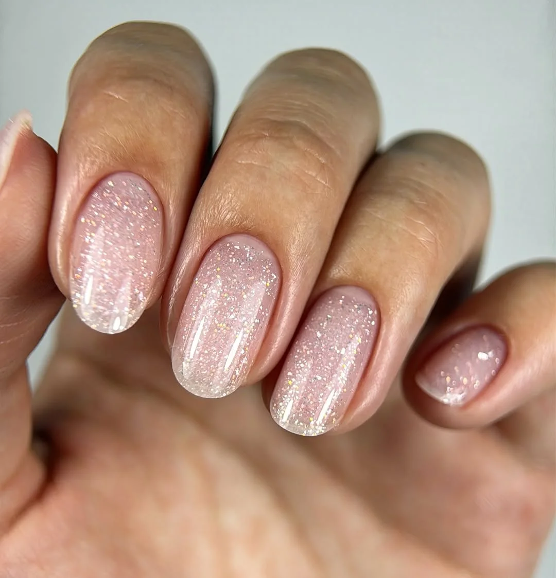short gel nails summer 2026 Soft Pink Glitter Nails With Fairy Light Shine