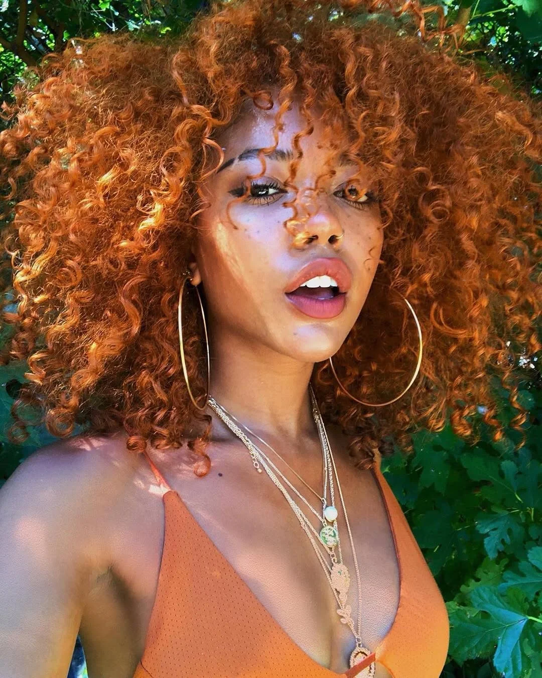 sleek summer hairstyle black women 2026 Sunlit Copper Curls With Wild Summer Texture
