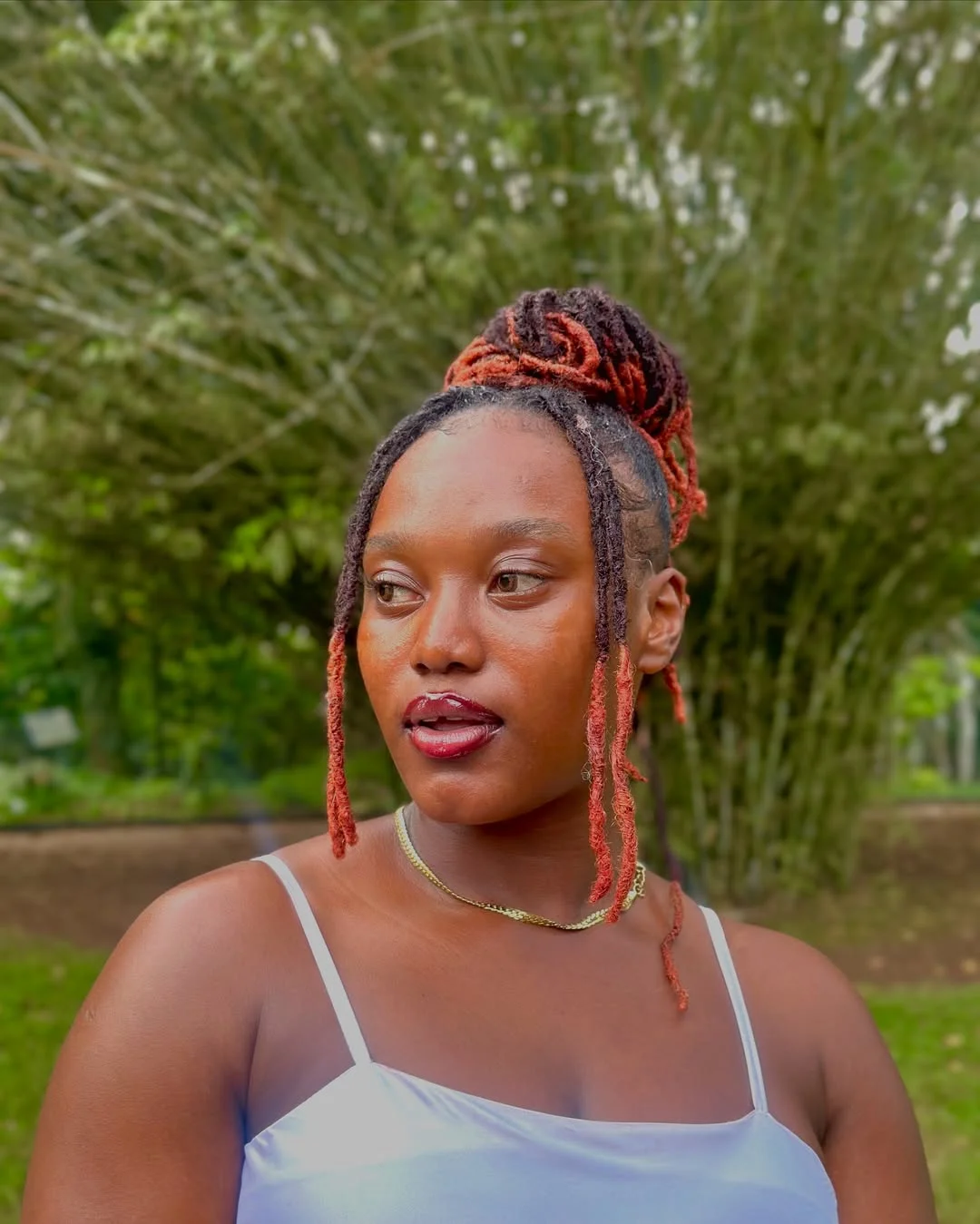 sleek summer hairstyle black women 2026 Copper-Tipped Loc Bun With Clean Summer Lines