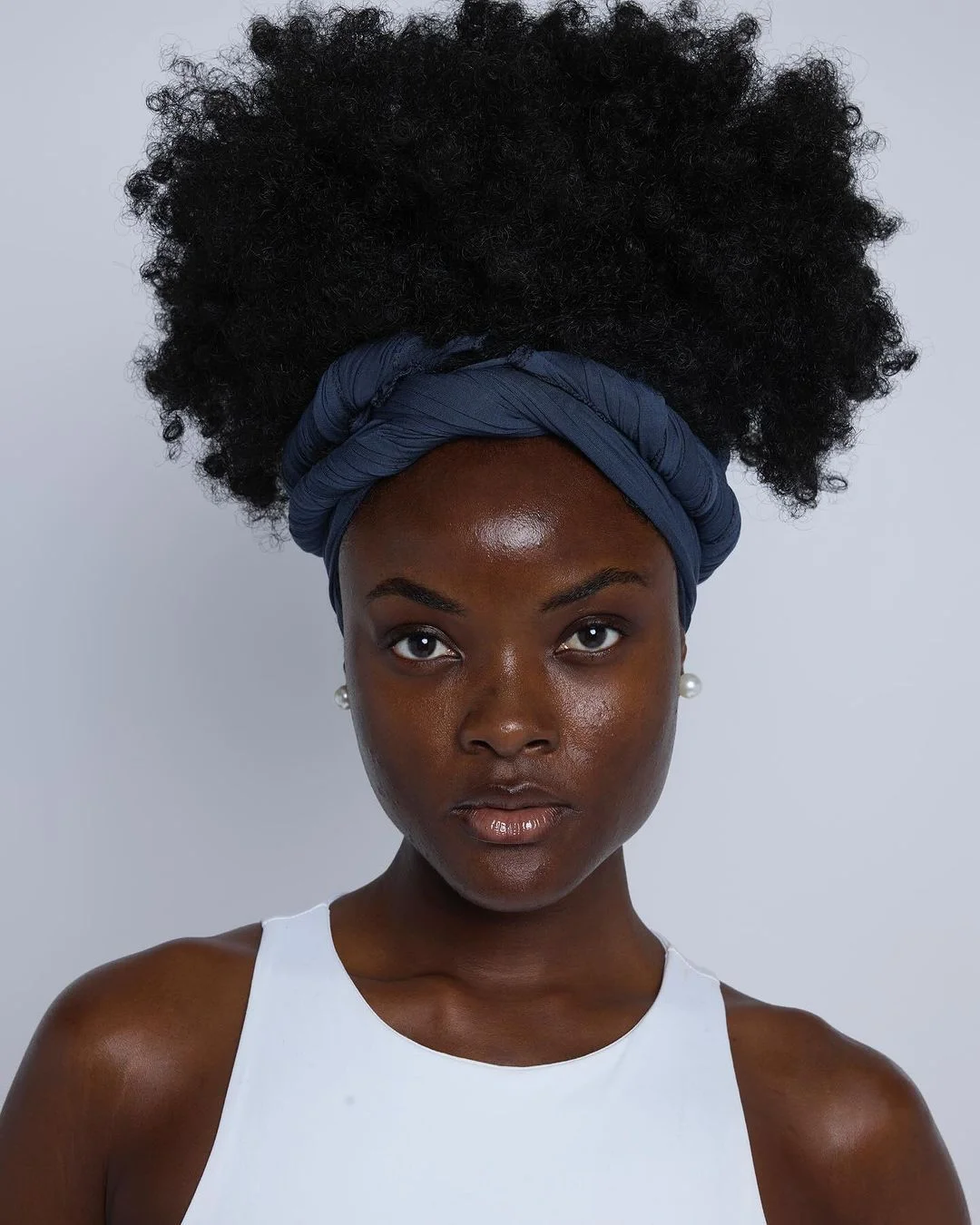 sleek summer hairstyle black women 2026 Cloud-Like Natural Puff With Wrapped Headband Detail