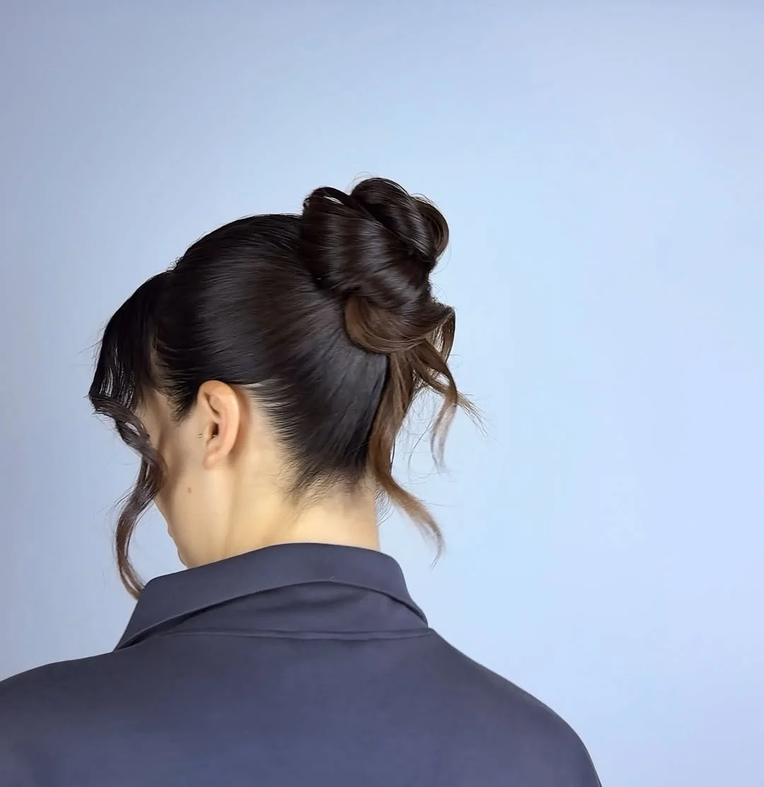 sleek summer updo hairstyles 2026 Twisted Sleek Top Knot With Soft Curled Tendrils