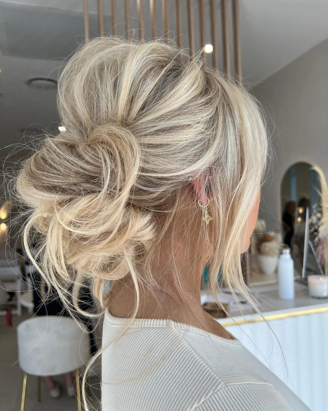 sleek summer updo hairstyles 2026 Airy Platinum Blonde Low Bun With Lived-In Texture