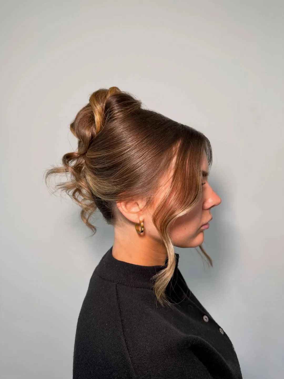 sleek summer updo hairstyles 2026 Soft Mocha Twist Bun With Loose Summer Waves
