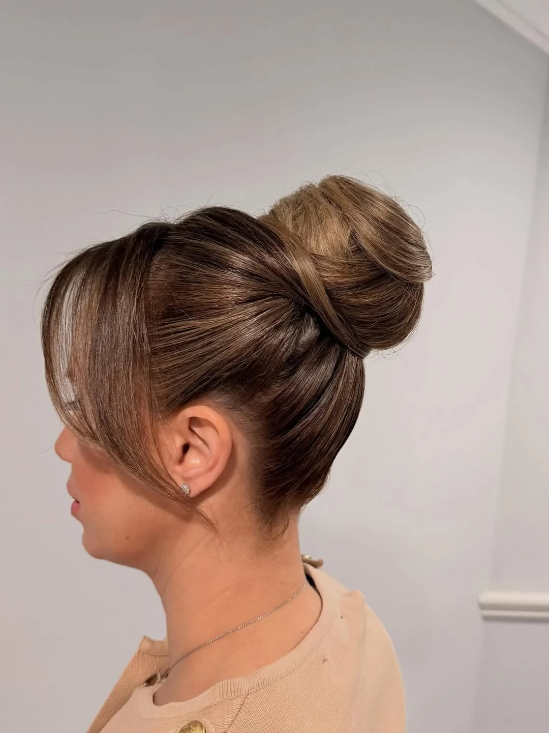 sleek summer updo hairstyles 2026 Polished High Bun With Glossy Espresso Shine