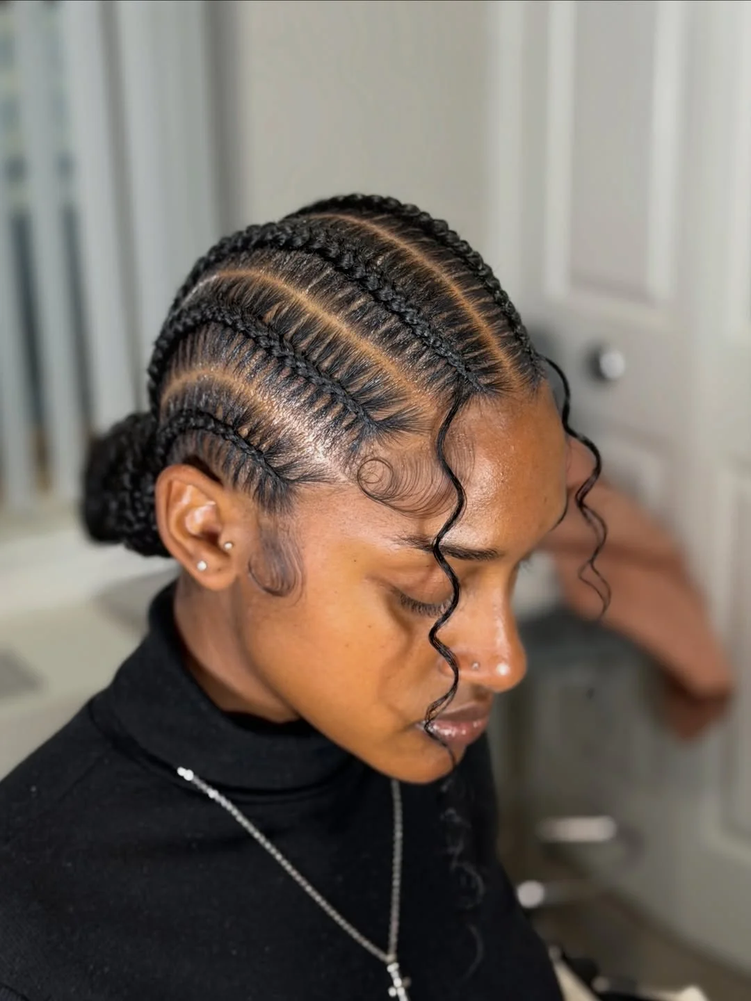 stunning summer hairstyles ideas 2026 Sleek Cornrow Bun with Sculpted Baby Hairs
