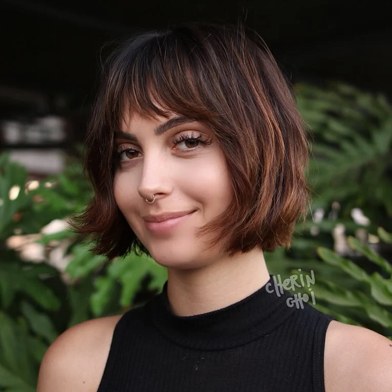 stylish summer haircut for round face 2026 Parisian Textured Bob With Wispy Fringe