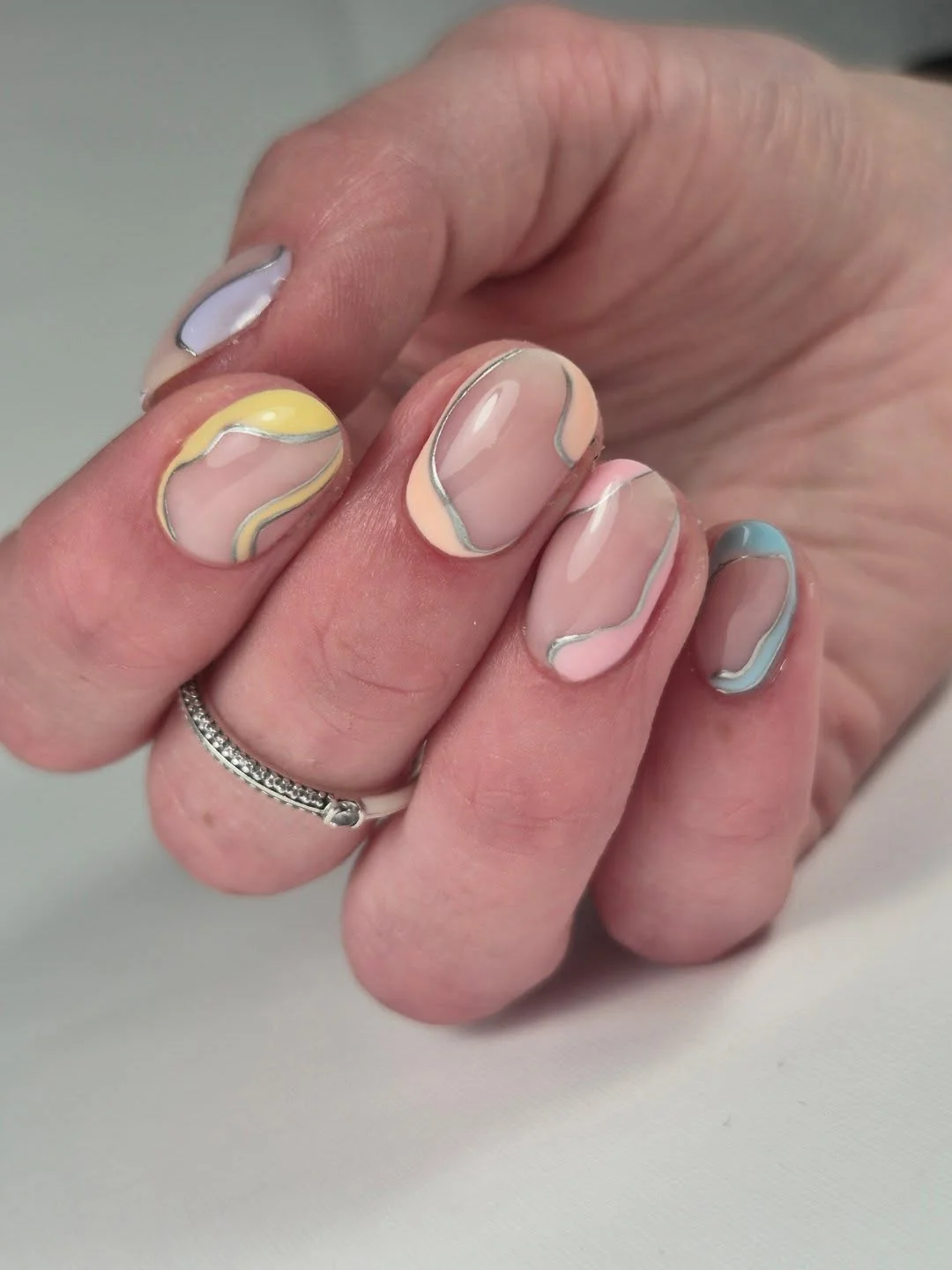 summer toe nails colors 2026 Abstract Pastel Swirl Nails With Delicate Silver Lines