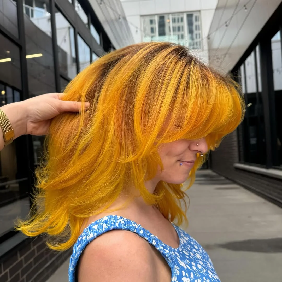 summer hair color ideas to inspire you 2026 Electric Marigold Layers - Bright Blonde Reinvented