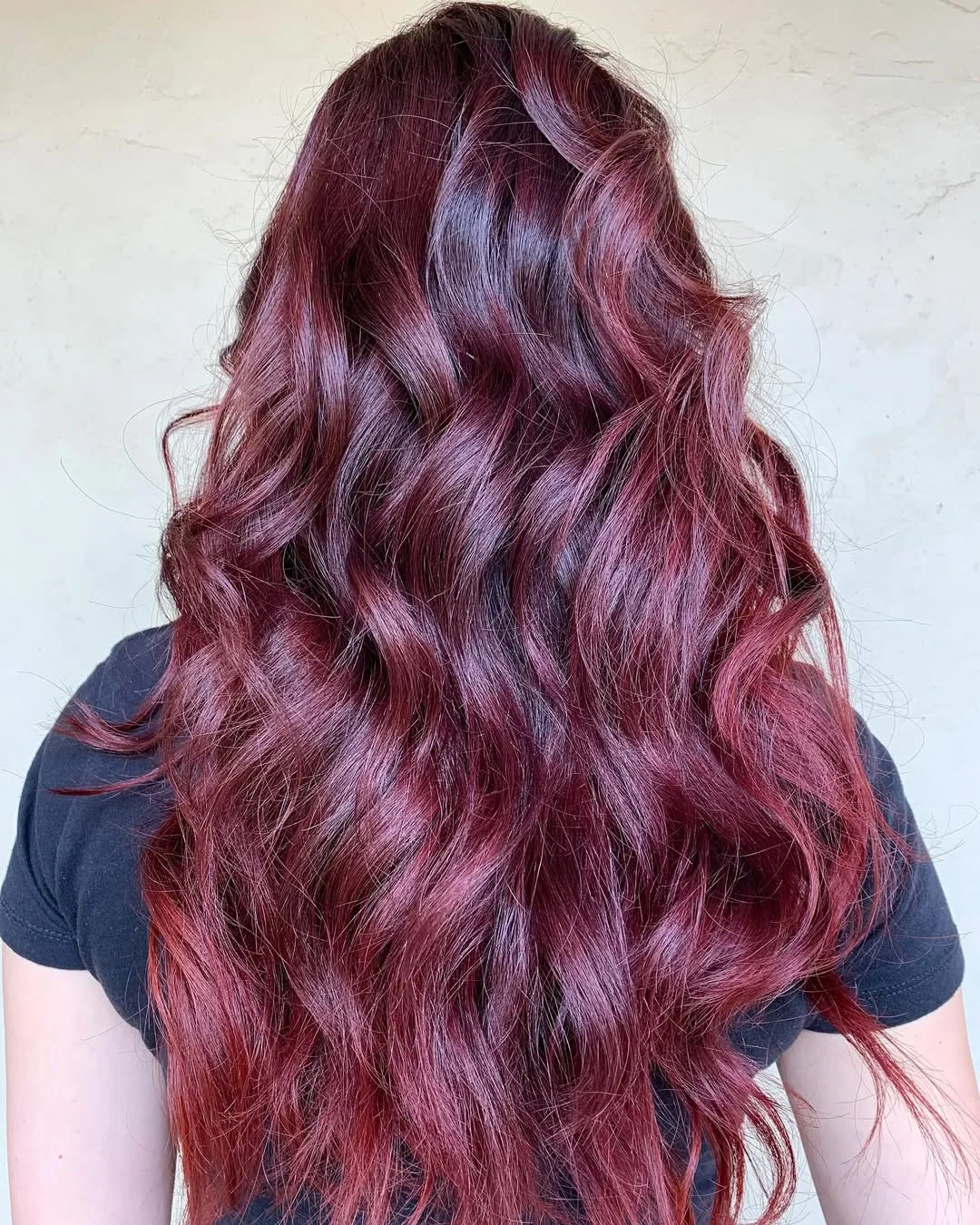 summer hair color ideas to inspire you 2026 Deep Wine Waves - Cool-Toned Red Reinvented