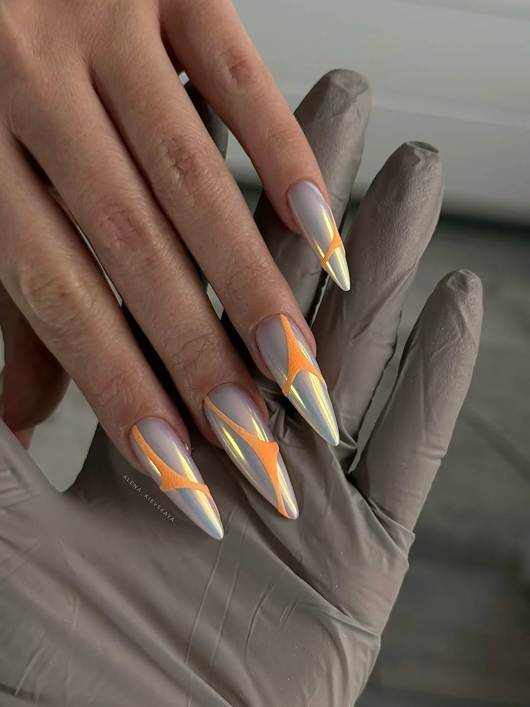 summer manicure color ideas 2026 Pearl Chrome Stiletto Nails With Neon Peach Accents