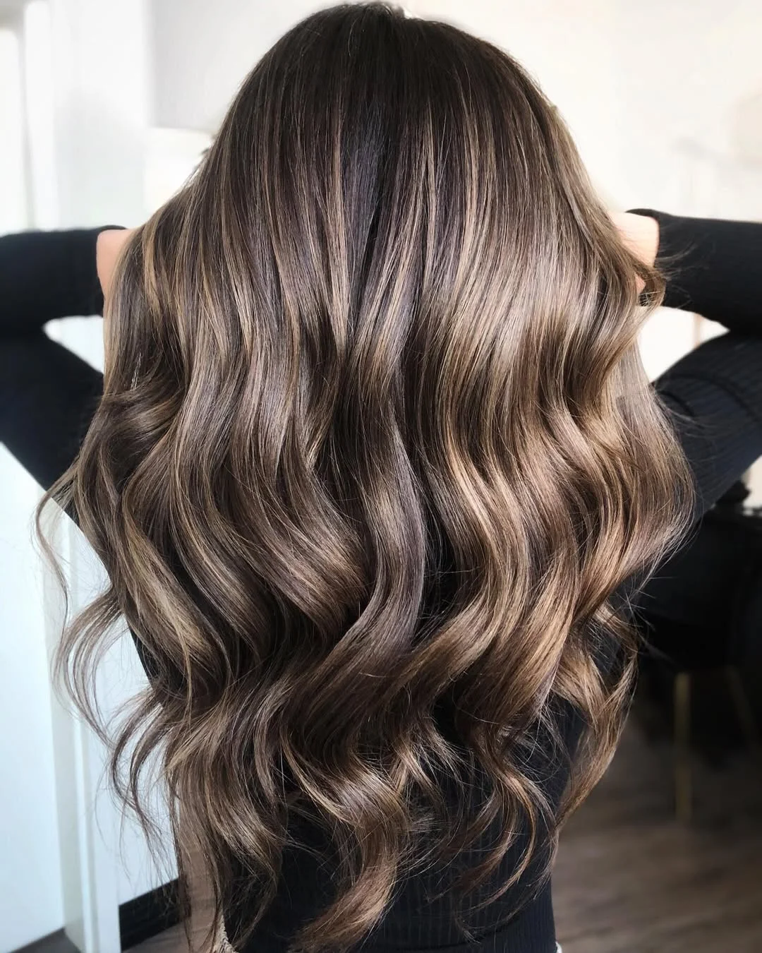 trendy summer brunette hair color 2026 Glossy Cocoa Brunette With Loose Defined Waves