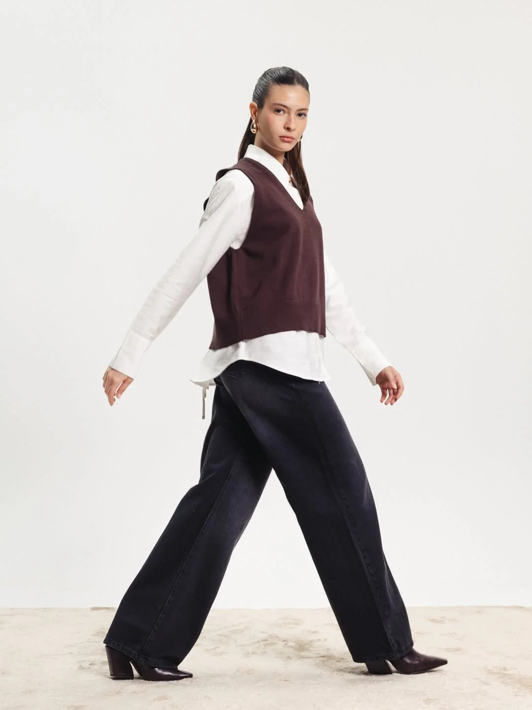 chic fall outfits pants 2026 Dark Denim And Sweater Vest Styling With Modern Western Energy