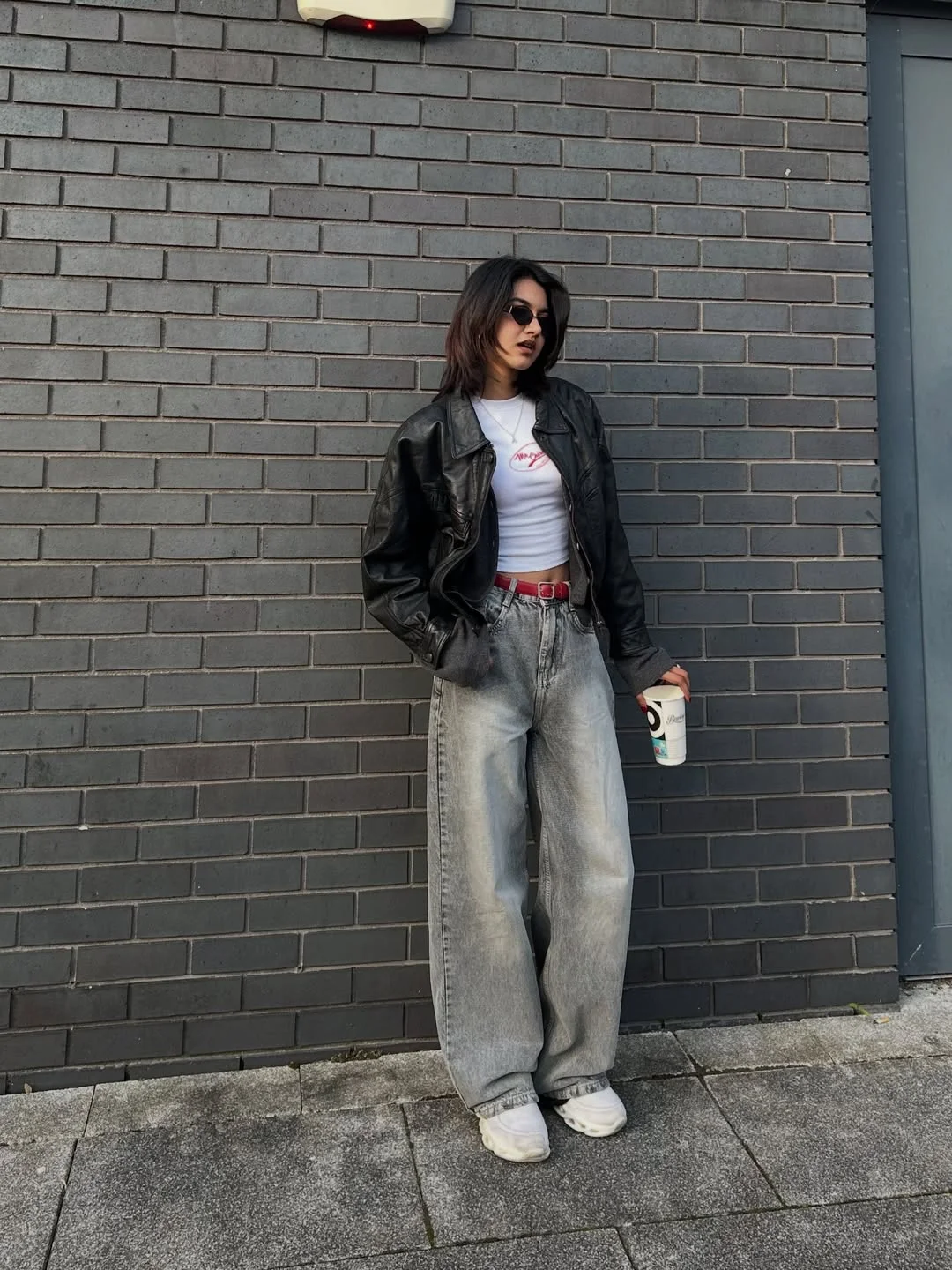 fall outfits with jeans and sneakers 2026 The Oversized Leather Jacket and Wide-Leg Denim Formula