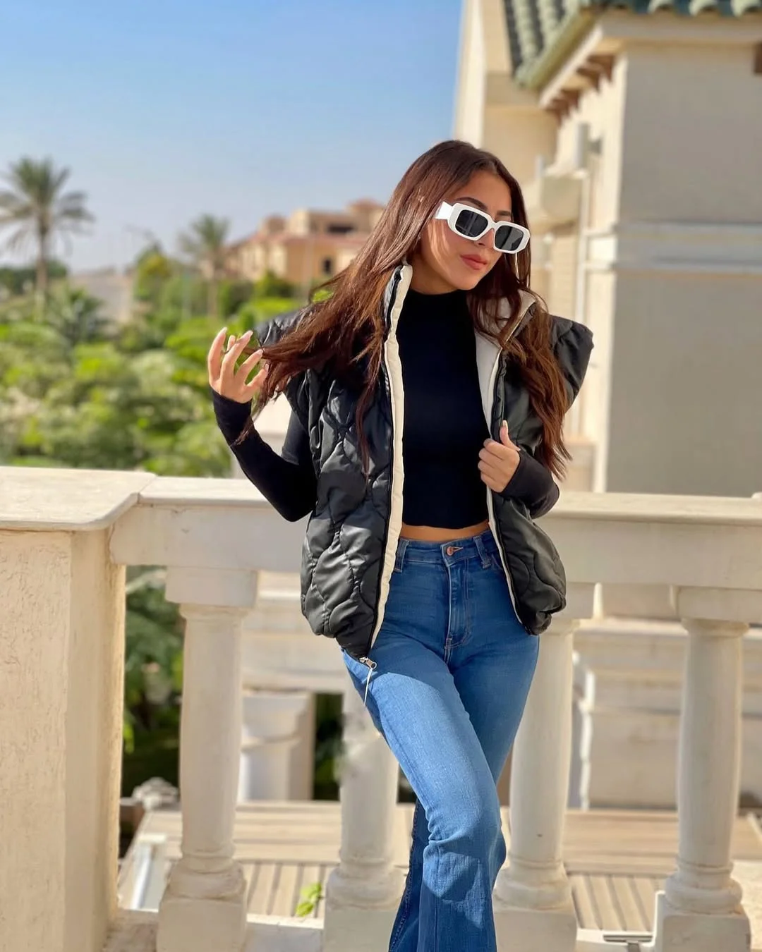 fall vest outfits for women 2026 Black Puffer Vest and Blue Jeans Make Everyday Style Effortless