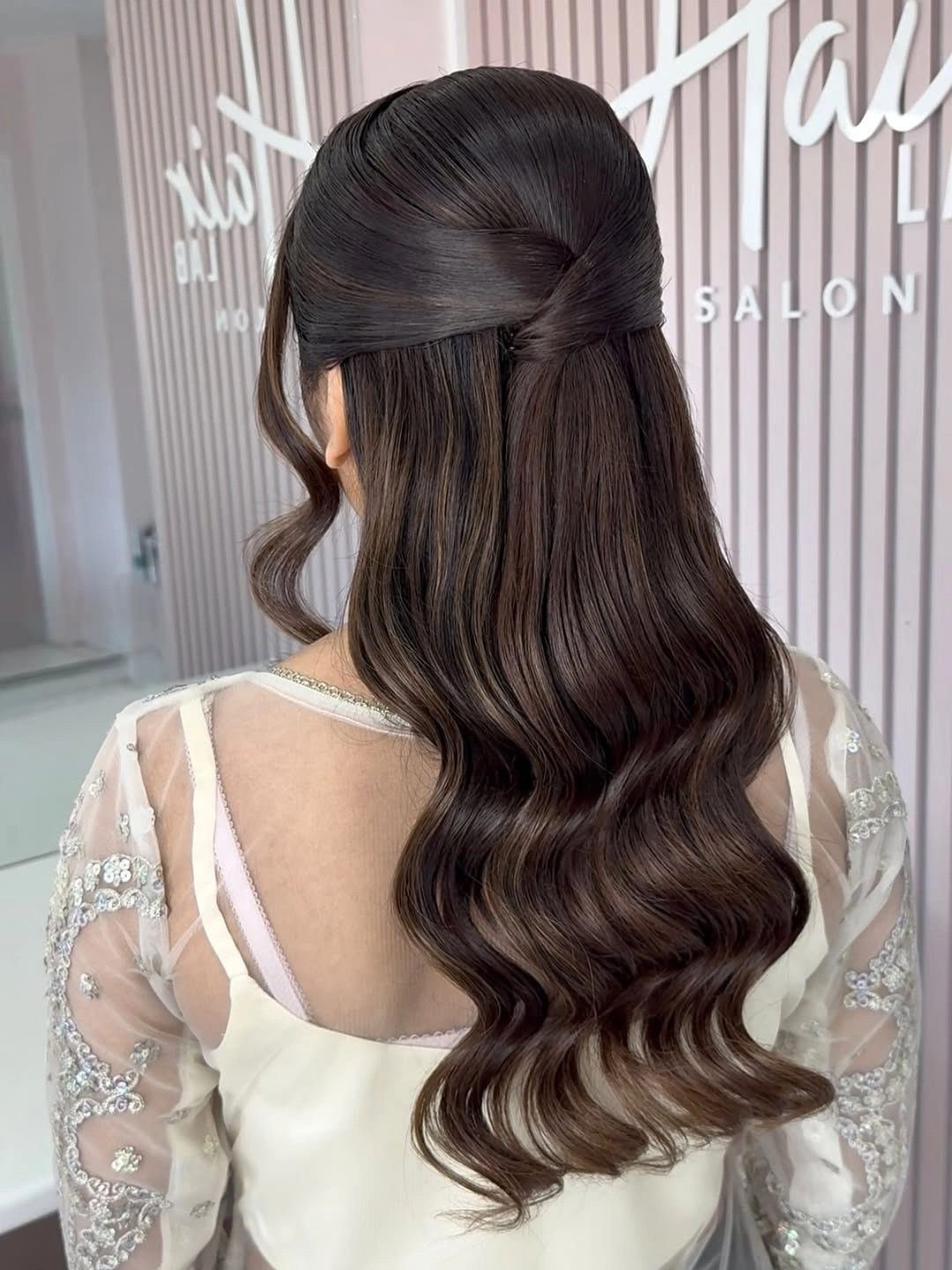 bridesmaid hairstyling Elegant Chocolate Brown Half-Up Waves with a Sleek Twist